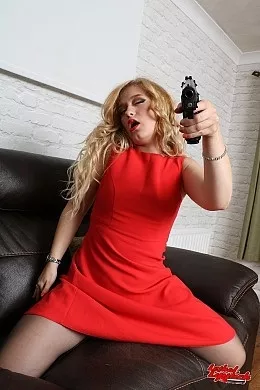 Darcy at Lethal Lipstick | Darcy is sat in her lounge wearing a red sheath dress