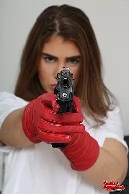 Katie Lou at Lethal Lipstick | Katie Lou is sat at her desk and she puts on a pair of red leather gloves