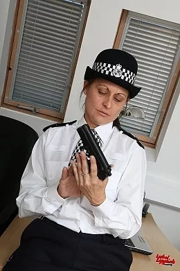 Shauna at Lethal Lipstick | Shauna in a white British Police Uniform with hat and black stockings