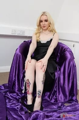Lana Harding at Sexy Satin Silk Fun | Delightful Lana Harding is sat in her chair, bare foot, she is wearing a rather nicely fitting long, black, strap top satin chemise . As she dangles a leg over the arm of the chair, she spreads her legs and we get a closer look at what she is wearing beneath the dress, a pair of soft, shiny, satin panties..perhaps we want more..