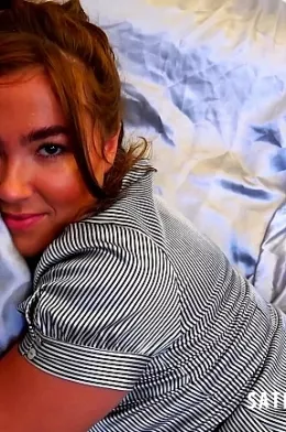 Lacy May at Satin Silk Fun | We find Lacy May sat on her sofa wearing a shiny short sleeved button up striped blouse and a knee length satin office style skirt. As she slips fiddles with the hem of her skirt we get a glimpse of the tops of her tan stockings and we begin to wonder what other treats she will tempt us with