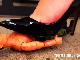 Elle Hunter at Tiny Fetish Fun | Office secretary Elle Hunter finds an 'all action' man standing to attention on her desk. She picks him up and inspects him before placing him flat on the floor and hovering her black patent leather high heels over him before removing her heels and stomping on him with her sweaty bare feet before tossing him away in the bin