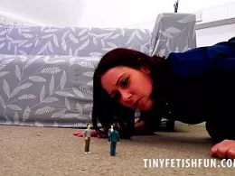 Belle O'Hara at Tiny Fetish Fun | Belle O'Hara was having such a good day and then she saw the group of tinies standing in the pile of her bedroom carpet looking up at her. Clearly they were trying to look up her skirt desperate for a glimpse of her knickers