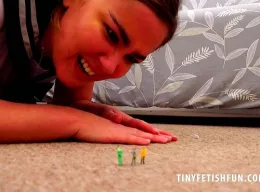 Lacy May at Tiny Fetish Fun | Lacy May in College Uniform discovers a group of tiny guys standing the pile of her carpet, they have no business being there