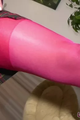 Pippa Doll at Upskirt Glamour | Behind-the-scenes video footage from shoot with Pippa Doll wearing a college uniform outfit comprising; Burgundy blazer, white shirt/blouse, tie, tartan patterned skirt, red matching bra/panties lingerie set, red stockings with black suspenders, and black high-heeled court shoes that stay on throughout, in a sensational tease to nude.