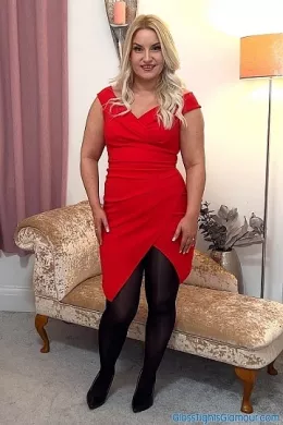 Irish Essie at Gloss Tights Glamour | Glorious VoP slow motion video footage from shoot with Irish Essie wearing a stylish figure-hugging red dress (sans bra), black glossy tights/pantyhose (sans briefs/panties), and black high-heeled court shoes that are subsequently removed, in a very naughty tease that sees her getting totally naked and having a lot of fun doing so!    4K Video download available