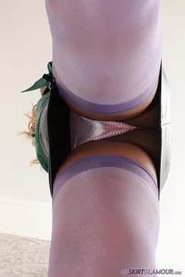 Aria at Upskirt Glamour | Stills photoset featuring Aria wearing a sexcretarial outfit comprising; emerald green silk/satin blouse/shirt, lilac lacey bra, black butt-hugging skirt, pastel pink briefs/panties, purple stockings & suspenders/belt, and black red soled high-heeled court shows that stay on throughout this mesmerising & exhilarating tease to topless with plenty of opportunities throughout for 'upskirt' views from all angles.