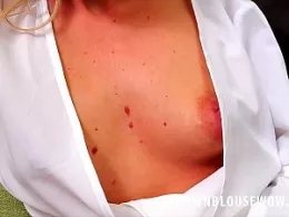 Toni at Down Blouse Wow | Toni is relaxing in her front room. She is wearing a knee length blue pleated skirt, tan stockings, high heels and a white wrap style blouse. As she sits there, she slowly and deliberately moves herself forwards giving her fans a sneak peek of her boobs and cleavage from beneath her outfit...and then a bit more..